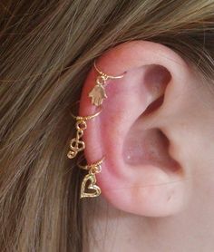 the ear is decorated with gold charms