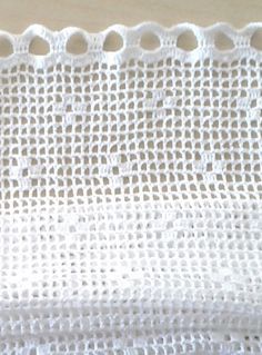 a white piece of cloth with holes in it