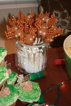 some cupcakes are sitting on a table next to other desserts and decorations