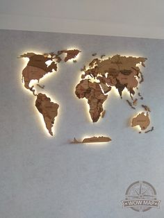 the world map is made out of wood and lit up with leds on it