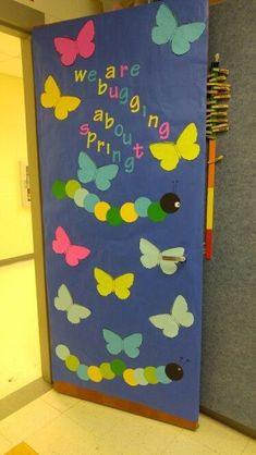 a bulletin board with butterflies on it and the words, we are bugging spring