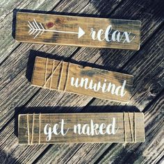 three wooden signs that say relax, unwind and get naked on wood planks