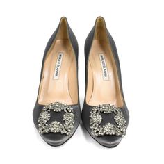 Manolo Blahnik 'Hangisi' pumps in grey satin with a crystal brooch in gunmetal hardware. Includes dust bag. Brand = Manolo Blahnik Condition = 9/10, Excellent. Size = 37.5 Heel Height = 100mm Material = Satin SKU = 23177-47 Luxury Pointed Toe Shoe Clips For Evening, Luxury Formal Shoe Clips, Embellished Evening Shoe Clips, Elegant Embellished Shoe Clips For Evening, Elegant Crystal Embellished Shoe Clips For Formal Occasions, Silver Shoe Clips For Evening, Elegant Silver Shoe Clips For Evening, Manolo Blahnik Hangisi, Gunmetal Hardware