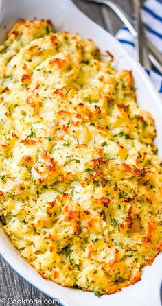 a casserole dish with broccoli and cheese in it on a table