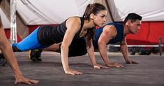 two people doing push ups on their stomachs