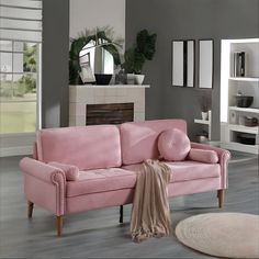 a living room with a pink couch and rug