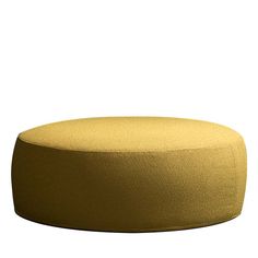 a round yellow ottoman sitting on top of a white floor