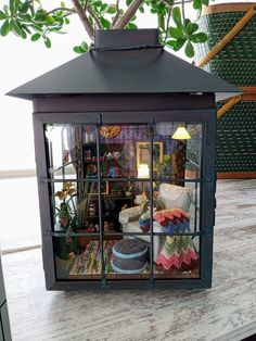 a small glass case on top of a wooden table