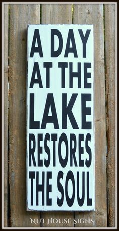 a sign that says a day at the lake restores the soul