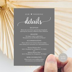 a person holding up a card that says, our wedding details reception and the wording on it