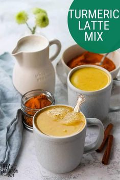 three mugs filled with different types of food on top of a white tablecloth