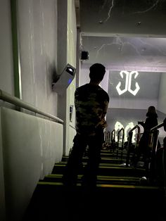 a man is standing in the hallway next to some stairs