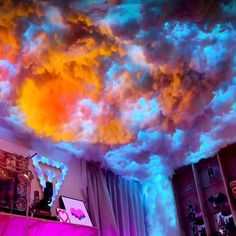 the clouds are glowing brightly in this room with pink and blue lighting on it's ceiling