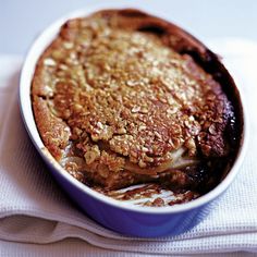 a baked dessert in a blue dish on top of a white cloth