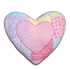 a heart shaped pillow with polka dots and hearts on it's sides, sitting in front of a white background