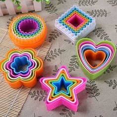 three cookie cutters with different shapes and sizes on a tablecloth next to each other