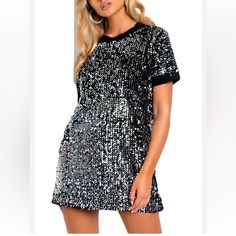 A Perfect Party Dress Mochy Sequin T-Shirt Mini Dress In Silver Black Detail Trim Around Sleeves And Neck Area Size-S/M (Measurements On Photos) New With Tags Fitted Silver T-shirt With Short Sleeves, Silver Crew Neck Top For Party, Silver Sequined Short Sleeve Tops, Glamorous Short Sleeve T-shirt For Night Out, Black Sequin Short Sleeve T-shirt, Silver Short Sleeve Dress For Night Out, Black Sequined T-shirt For Party, Black Short Sleeve T-shirt For Party Season, Silver Short Sleeve T-shirt For Summer