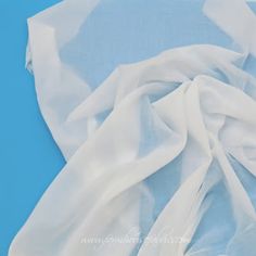 white fabric on blue background with copy space