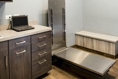 a laptop computer sitting on top of a kitchen counter