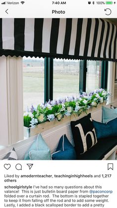 an instagram page with a black and white striped awning over a couch in front of a window