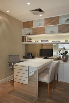 a white desk and chair in a room with wood flooring, built - in shelving