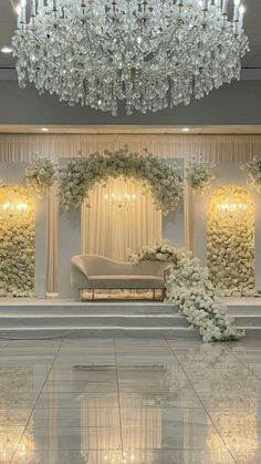 an elegant wedding setup with flowers and chandelier