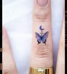 a small butterfly tattoo on the ring finger is shown in three different positions, one with a cross and one with a crescent moon