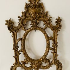 an ornate gold frame hanging on the wall