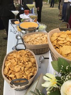 a table topped with baskets filled with chips