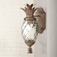 a wall mounted light with a pineapple design on it