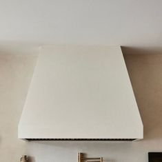 a white stove top oven sitting inside of a kitchen next to a wall mounted tv