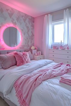 a bed with pink pillows and blankets in front of a round mirror on the wall