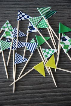 several small green and blue pinwheels on wooden sticks