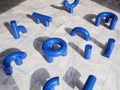 blue letters and numbers are arranged on the floor