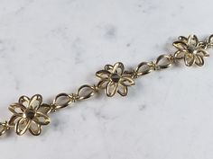 "A WOMEN'S VINTAGE ESTATE 14K YELLOW GOLD FLOWER BRACELET THAT WAS MADE IN ITALY. THE BRACELET MEASURES 7 1/2\" LONG BY ABOUT 7/8\" WIDE, AND WEIGHS 9.9g. THIS WOULD MAKE A LOVELY GIFT AND IS A GREAT VALUE FOR THE MONEY. IF ANY OTHER QUESTIONS, PLEASE ASK. BE SURE TO CHECK OUT SOME OF MY OTHER GREAT ITEMS UP FOR SALE. THANK YOU" Estate Style 14k Yellow Gold Jewelry, Yellow Gold Estate Jewelry, Estate Yellow Gold Jewelry For Formal Occasions, Formal Estate Yellow Gold Jewelry, Formal Yellow Gold Flower Bracelet, Formal Flower Shaped Polished Jewelry, Estate Jewelry Gold Stamped 14k, Gold Estate Jewelry Stamped 14k, Estate Style 14k Stamped Gold Jewelry