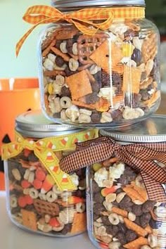 three glass jars filled with different types of snacks