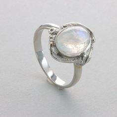 This is a beautiful Rainbow Moonstone Ring in 925 Sterling Silver with a Rhodium finish.  The silver does also not include any nickel or other substances causing most allergies. The ring is thus hypoallergenic. Rhodium makes the silver less tarnish. Size of the Moonstone 1.1 x 0.8 cm 0.43 x 0.31 inch Please note: Our jewelry is photographed close up to show detail and may appear larger than they are. We use a dime coin as size reference on one of the pictures. Usually we ship on the same day we receive the payment for the order. You will receive the item in a gift box - perfect to surprise someone or yourself. We want you to be happy with your purchase. If you do not like what you bough can send it back and we will refund you the money. Please do not hesitate to contact us so we can solve Polished Silver Gemstones For Wedding, Wedding Silver Polished Gemstones, Silver Sterling Silver Moon-shaped Opal Ring, Silver Moon-shaped Sterling Silver Opal Ring, Silver Sterling Silver Moon Shaped Opal Ring, Moon Shaped Moonstone Ring In Sterling Silver, Sterling Silver Moonstone Ring In Moon Shape, Sterling Silver Moonstone Ring Shaped Like Moon For Promise, Sterling Silver Moonstone Ring In Moon Shape For Promise