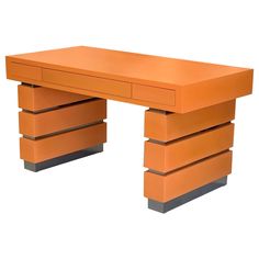 an orange desk sitting on top of a white floor