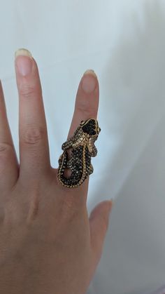 size approximately 7 to 7.5, very good condition, no missing stones or scratches. Rhinestone Ring, Ring Black, Gecko, Black Rings, Statement Ring, Rings Statement, Black And Gold, Halloween Shopping, Statement Rings