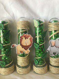 there are many green candies wrapped in twine with animals on them and tied together