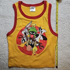 New Without Tags Looney Tunes Yellow With Red Trip Tank Top, Size Small. Fun Yellow Sleeveless Top, Yellow Playful Fitted Tops, Playful Fitted Yellow Tops, Fitted Playful Yellow Tops, Fitted Yellow Playful Tops, Fun Red Sleeveless Top, Harry Potter Tank Top, Bird Shirt, Small Tank