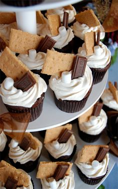 cupcakes are arranged on three tiered plates