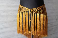 Hip scarf belt for belly dance crochet off viscose yarn in deep gold color *super shimmery and pleasant to the touch *Has a long adjustable cord  *Size- length with fringe- 21,6"(55cm) Width of the triangle part- 31,4" (80cm)  length of the cord- 47.2"(120cm) *Custom colours and sizes available,just tell me your measurements *Care instructions- hand wash in warm water Other hip scarves you can see here: https://www.etsy.com/shop/LacyStories?ref=seller-platform-mcnav&section_id=27353438 Fitted Gold Shawl For Party, Gold Fitted Shawl For Party, Belly Dance Hip Scarf, Belt Scarf, Fringe Belt, Hip Scarf, Macrame Dress, Hip Scarves, Fringed Belt