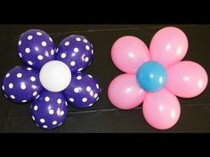 two balloons with polka dots on them and a flower shaped balloon in the shape of a flower