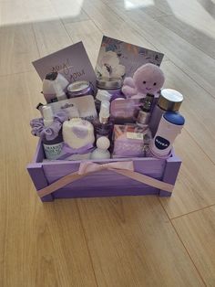 a purple box filled with lots of items on top of a wooden floor