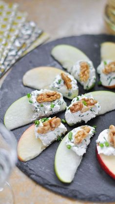 there are apples with cream cheese and walnuts on the top, along with crackers