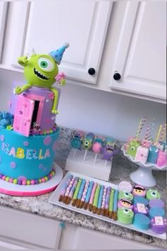 a birthday cake decorated with monsters and candy