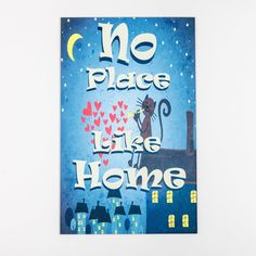 there is a poster on the wall that says no place like home with a cat holding a heart