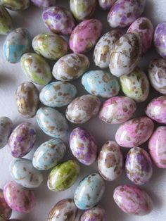 some very pretty looking eggs on a white tablecloth with gold speckles and green spots