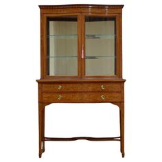 a wooden cabinet with glass doors and drawers